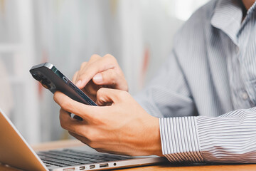 Laptop, hands and businessman with cellphone in office for online email communication for corporate review. Technology coffee and hr with computer and phone for reading company policy on internet,