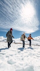 Three women walking on snow under a cloudy sky
