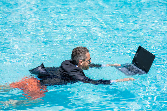 Man using laptop for freelancing in pool. Business freelancing. Businessman on summer vacation. Businessman using webcam for video. Freelance man has online video call. Freelance working online - Powered by Adobe