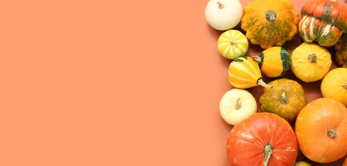 Many pumpkins on orange background with space for text, top view