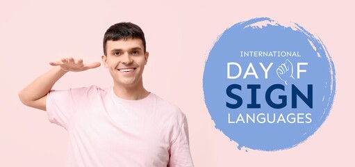 Young deaf mute man on pink background. Banner for International Day of Sign Languages