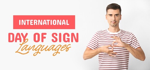 Young deaf mute man on light background. Banner for International Day of Sign Languages