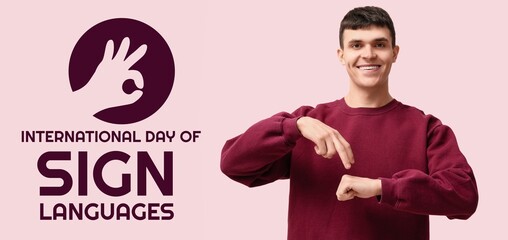 Young deaf mute man on pink background. Banner for International Day of Sign Languages