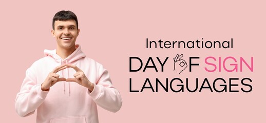 Young deaf mute man on pink background. Banner for International Day of Sign Languages