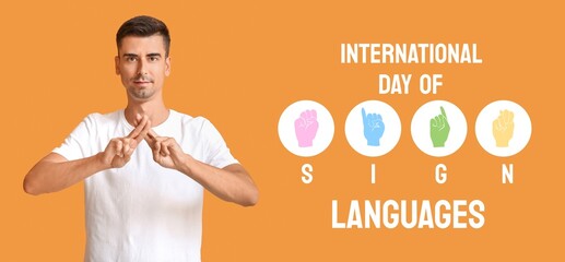 Young deaf mute man on orange background. Banner for International Day of Sign Languages