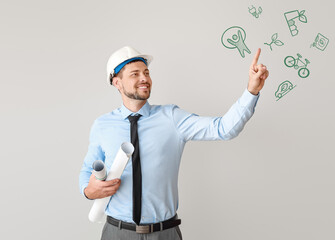 Male engineer showing something on light background