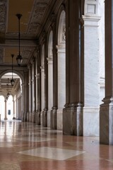 Elegant marble archway in an historic building with intricate ceiling details and soft natural light