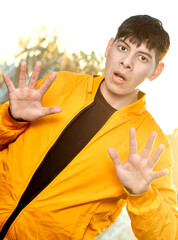 Young Latino Man Hands Raised: Startled / Defensive Expression
