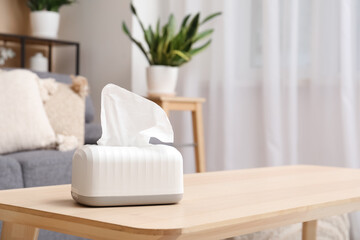Tissue in ceramic holder on coffee table in living room. Closeup