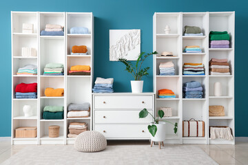 Walk-in closet with  chest of drawers and stylish female clothes in room