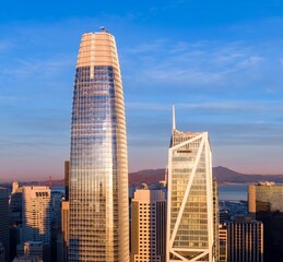 San Francisco, USA: A high-angle view of the city skyline at sunset, showcasing the Salesforce Tower and the Transamerica Pyramid. The photo captures the city's architecture.