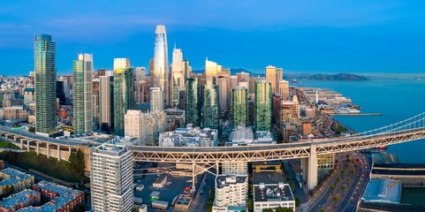 Aerial view of the San Francisco skyline at sunset, showcasing the Salesforce Tower and Bay Bridge...
