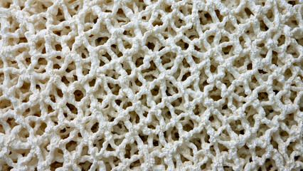 Intricate coral and white woven pattern close-up