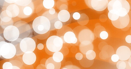 Displaying blurred light circles in abstract orange backdrop, with soft bokeh effect