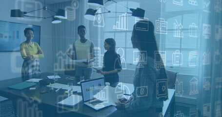 Discussing four women in suits collaborating at office conference table, with laptops, data overlay