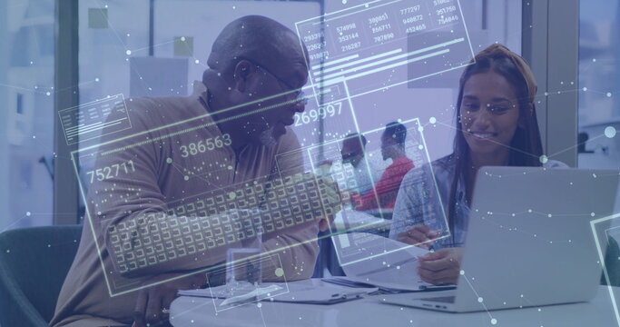 Mentor in beige sweater and woman with yellow headband reviewing documents, data overlays in office
