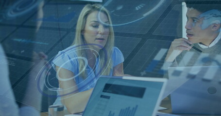 Reviewing woman analyzing charts at table, laptops, notebook pen, glass  and  virtual overlay