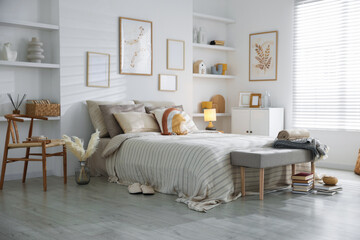 Obraz premium Comfortable bed with soft linens in room. Home textile