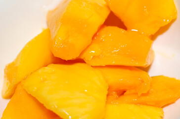 Fresh Mango Pieces Ready to Eat. Sweet Fruit Snack. Mango pieces ready for consumption.