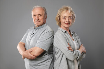 Portrait of lovely senior couple on grey background