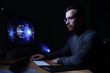 Engineer working with digital drawing at table in office