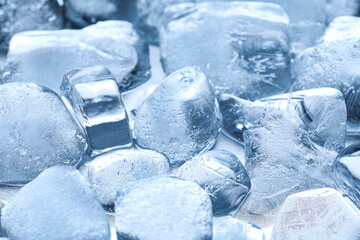 Texture of frozen ice cubes on light background, closeup
