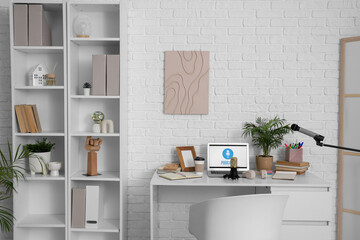 Interior of podcaster's studio with workplace and shelf unit