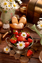 A bowl of fresh strawberries on wooden table