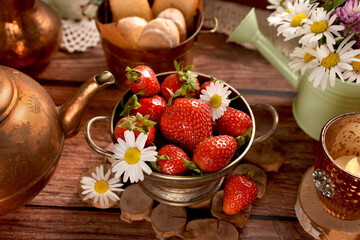 A bowl of fresh strawberries on wooden table