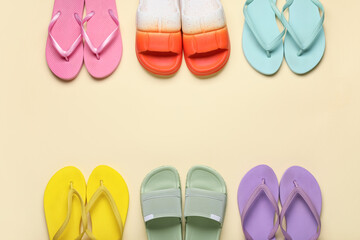 Frame made of different stylish flip-flops on beige background