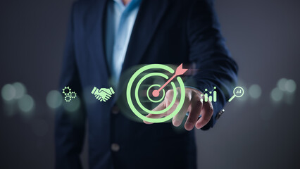 Goal achievement, strategic planning, successful execution for business growth and market success. Businessman points at a glowing target icon, surrounded by digital business solution symbols.
