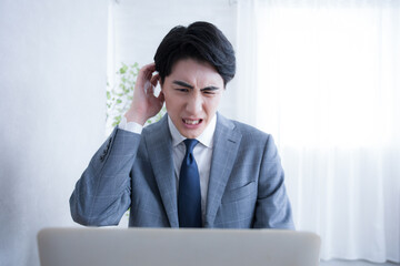 Looking at the computer Businessman who has trouble making mistakes or forgetting tasks or...