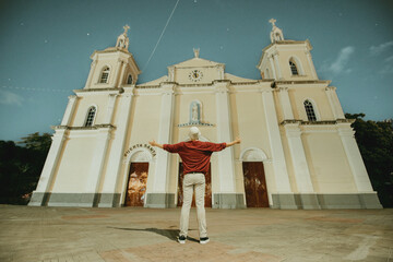 Tourist with open arms at the Esteli Cathedral, Nicaragua. Man with open arms at the Esteli Cathedral, Our Lady of the Rosary