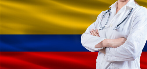 Doctor with crossed arms on Colombia flag. Colombia health and care concept. Female doctor on Colombia flag