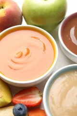 Baby food. Tasty puree in bowls and different ingredients on table, above view