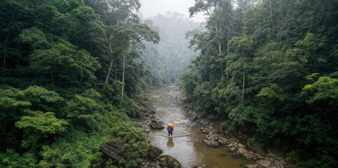 Aerial view captures a smuggler with a large contraband backpack attempting to cross a remote, misty jungle river. Concept of illegal border crossing, crime, illicit trade, remote location, danger. 