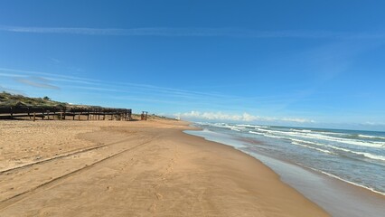 A stunning and picturesque beach on a beautiful sunny day, showcasing soft golden sand and gentle ocean waves