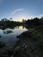 Lake park view and behind modern buildings silhouette at sunset in Istanbul, Turkey.