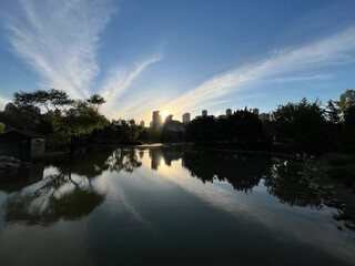 Lake park view and behind modern buildings silhouette at sunset in Istanbul, Turkey.