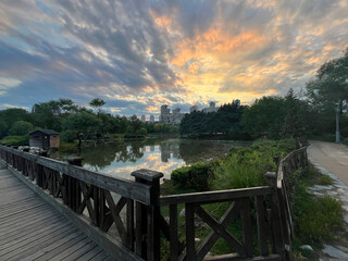 Wooden bridge and lake park view silhouette at sunset in Istanbul, Turkey.