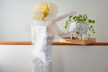 Cool picture of a lady styling an indoor plant