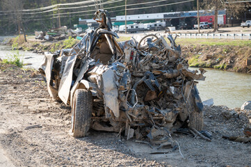 broken car and metal on road