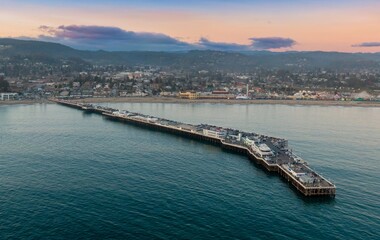 Santa Cruz Wharf extends into Monterey Bay, California, USA. People visit the pier for dining,...