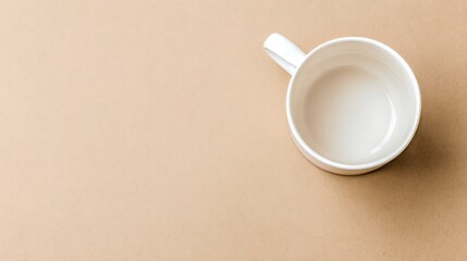Empty white mug on beige surface