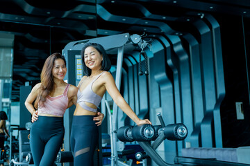 Multiethnic group young fitness women training at the gym. Athletic women doing stretches and warming up before workout.