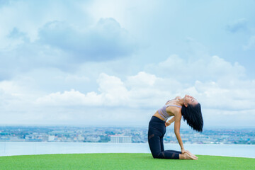 yoga, Asian woman wearing yoga clothes practicing yoga, Asia group of women exercising healthy lifestyle in outdoor fitness studio. swimming pool. Sport activity, gymnastics or ballet dancing class.