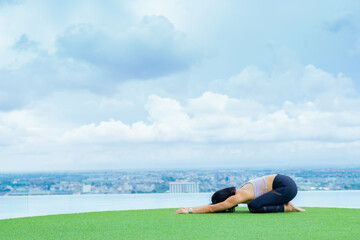 yoga, Asian woman wearing yoga clothes practicing yoga, Asia group of women exercising healthy lifestyle in outdoor fitness studio. swimming pool. Sport activity, gymnastics or ballet dancing class.