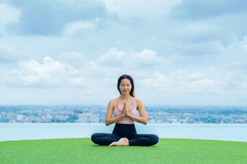 yoga, Asian woman wearing yoga clothes practicing yoga, Asia group of women exercising healthy lifestyle in outdoor fitness studio. swimming pool. Sport activity, gymnastics or ballet dancing class.