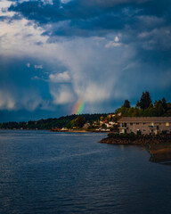 Rainbow shining over houses in Port Orchard, Washington at the Port Orchard Marina