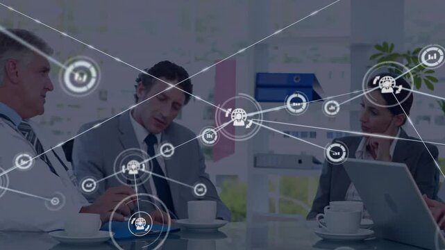 Manager writing and nurse typing on laptop initiating network overlay illustrating medical strategy